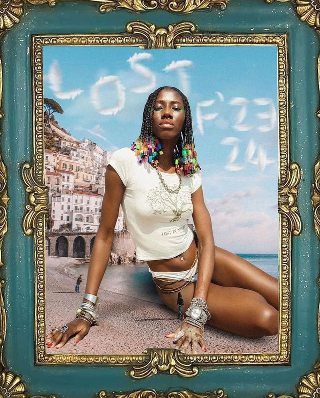 Collage in an ornate gilded frame: model reclining on a coastal beach with Lost F23 24 written in clouds.