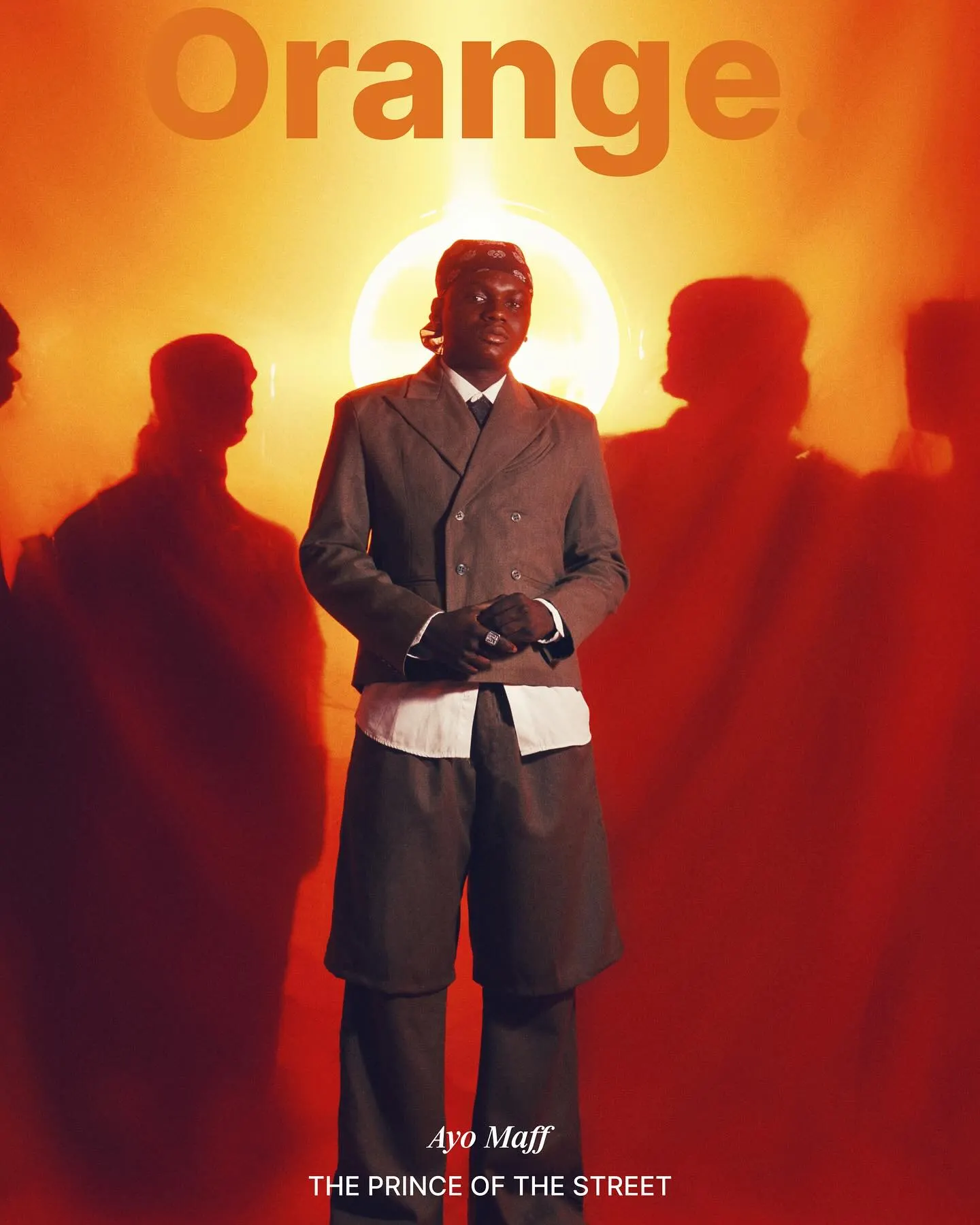 Orange magazine cover — Ayo Maff in a grey double-breasted suit standing before a glowing halo, shadowy figures gathered in the red-orange haze, titled 'The Prince of the Street'.