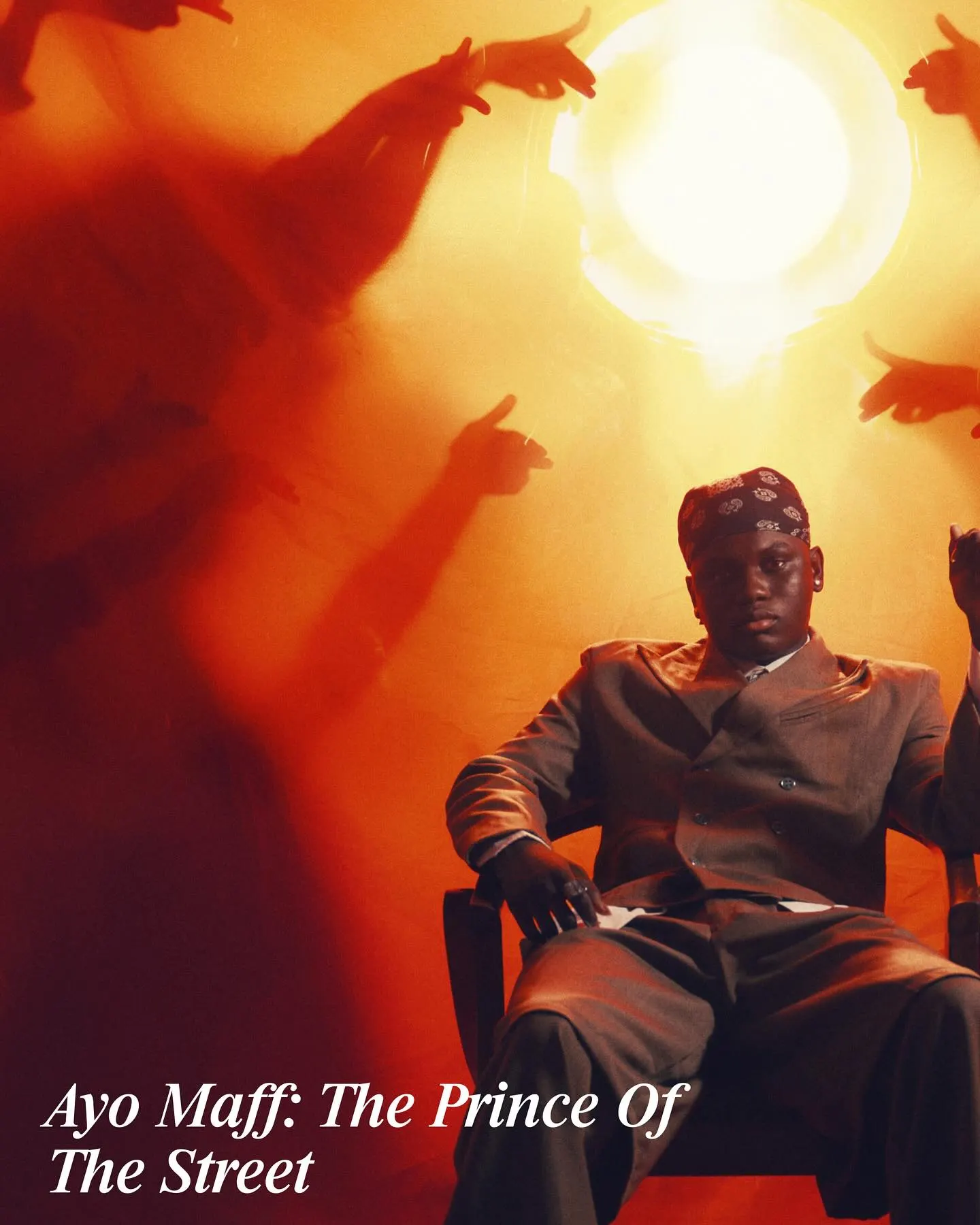 'Ayo Maff: The Prince of The Street' title card — the artist slouched in a chair in bandana and grey suit while silhouetted hands point at him under a blazing orange light.