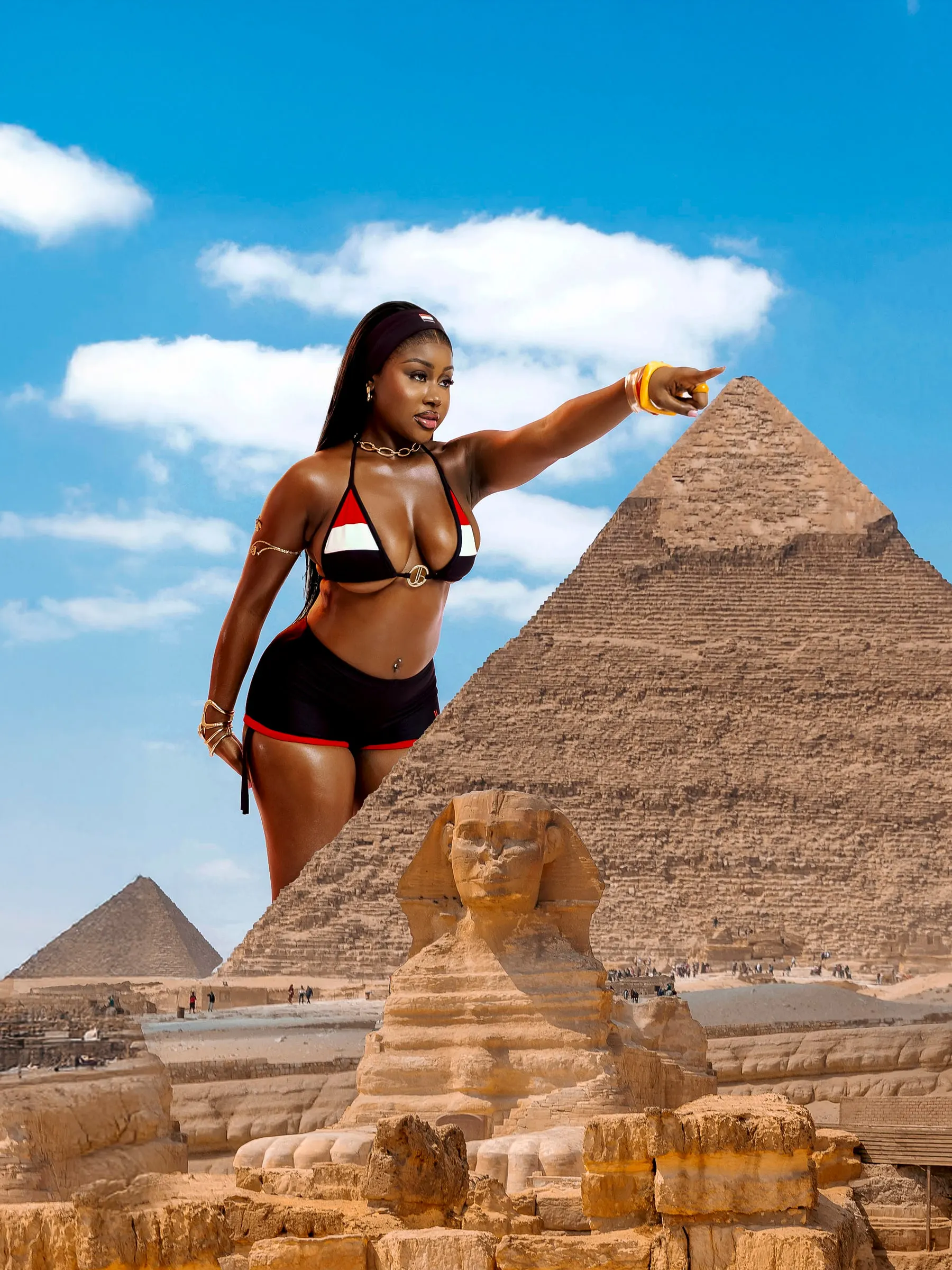 Composite: a model in a red, white and black bikini points along the slope of a Giza pyramid, the Sphinx at her feet under a blue sky.
