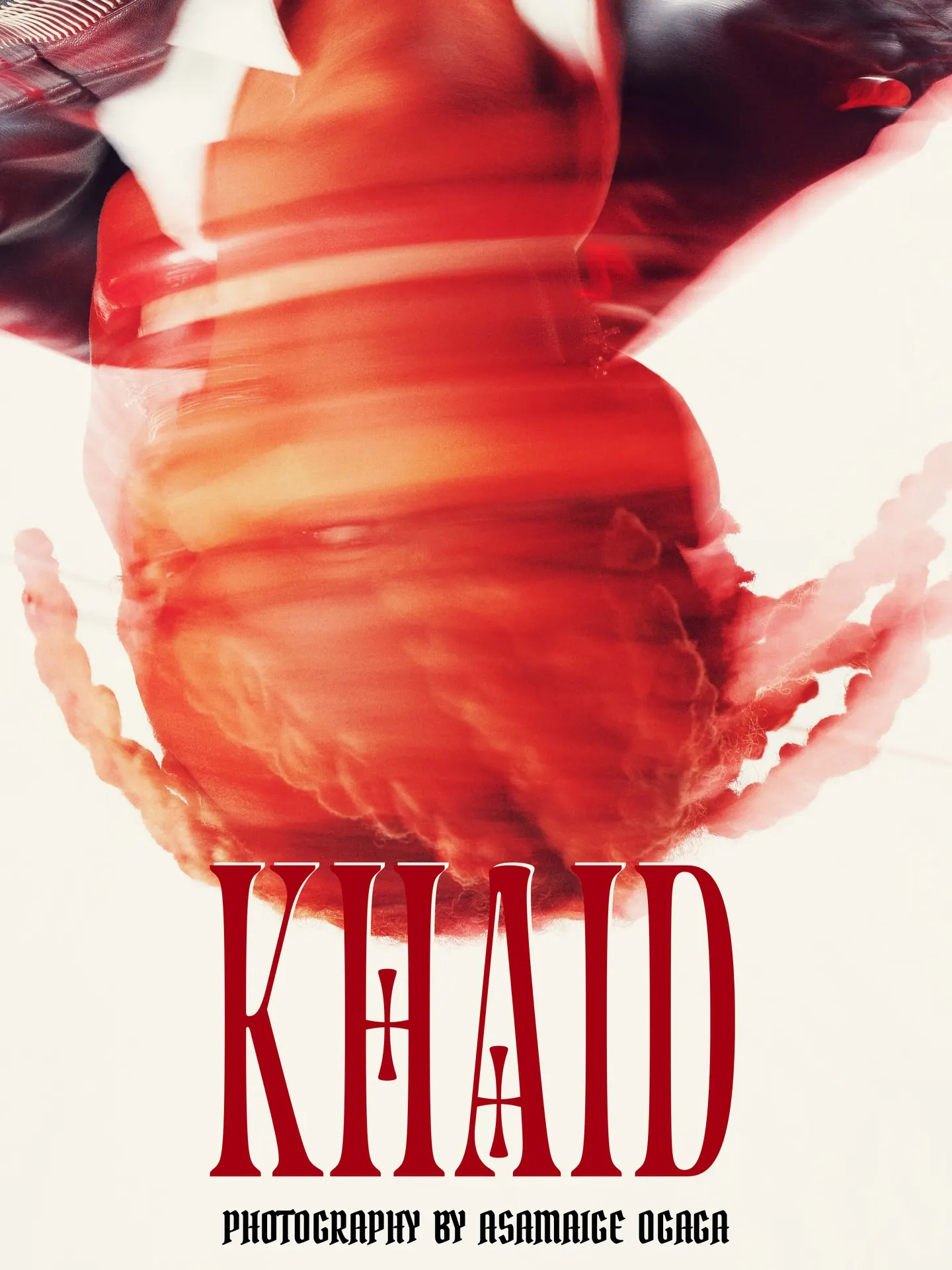 KHAID title card — an upside-down blur of the artist's braided head in red, deep-red type and the credit 'Photography by Asamaige Ogaga' along the bottom on white.