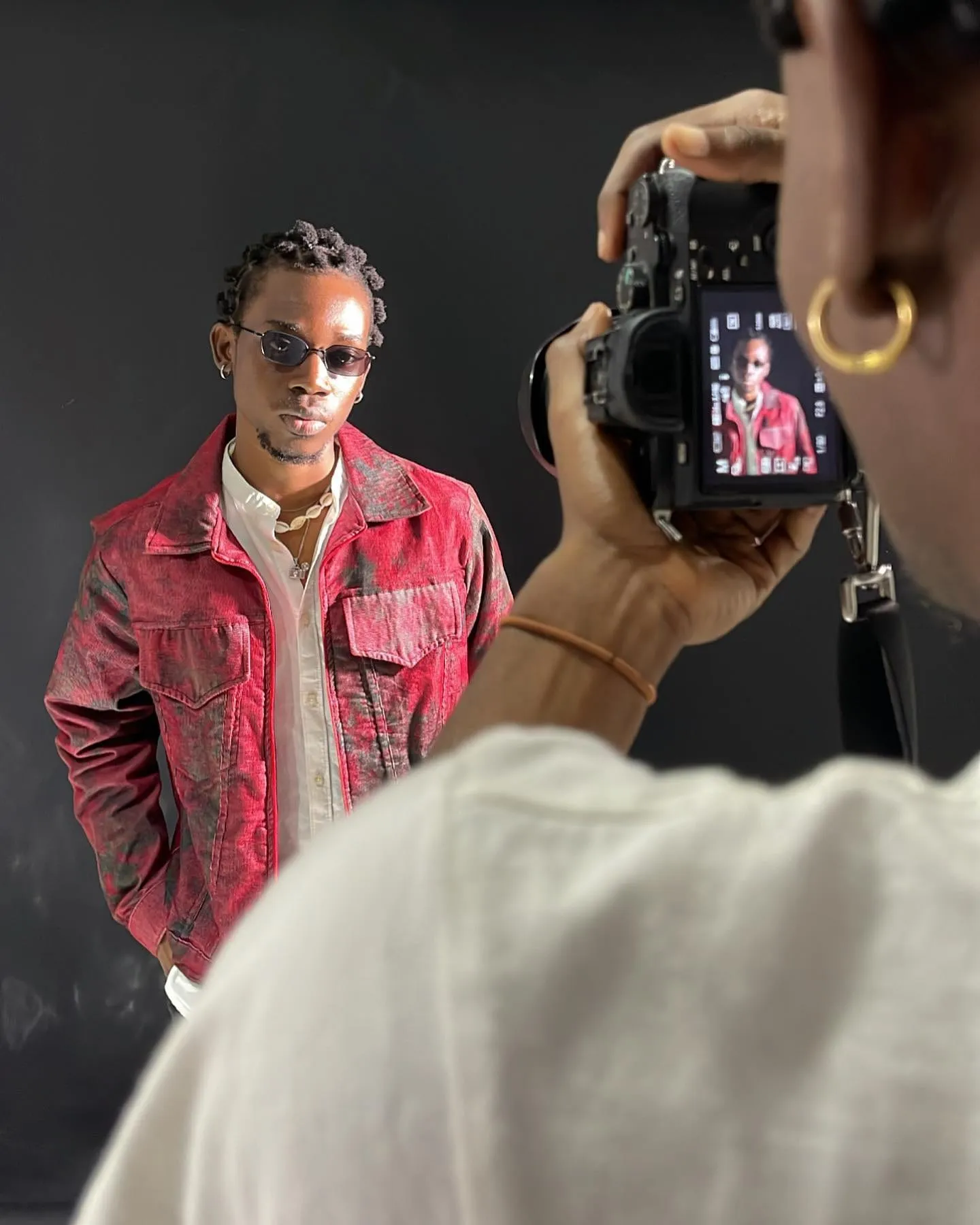 Ogaga Asamaige photographed outdoors in a statement coat.