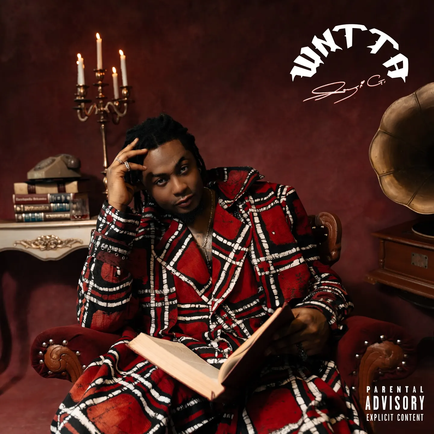 Cover of Seyi G's WNTTA: the artist in a red plaid Ankara coat lounges in a crimson armchair with an open book, flanked by a candelabra and gramophone under arched white lettering.